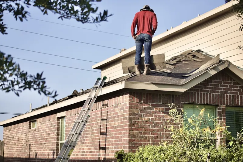 Professional roofer working on a residential roof in Marlboroville